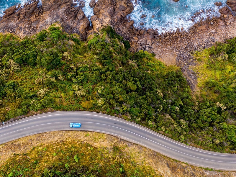 The EV is no longer restrained to city driving, aerial shot car on road